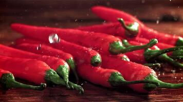 Drops of water fall on chili peppers. Filmed on a high-speed camera at 1000 fps. High quality FullHD footage video