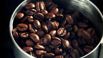 Coffee beans fall into the bowl. Filmed on a high-speed camera at 1000 fps. High quality FullHD footage video