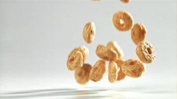 Corn flakes falling on white background. Filmed on a high-speed camera at 1000 fps. High quality FullHD footage video