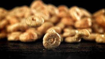 Corn flakes falling on black background. Filmed on a high-speed camera at 1000 fps. High quality FullHD footage video