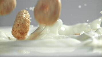 Corn flakes fall into the milk. Filmed on a high-speed camera at 1000 fps. High quality FullHD footage video