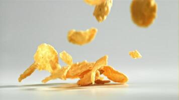 Corn flakes falling on white background. Filmed on a high-speed camera at 1000 fps. High quality FullHD footage video