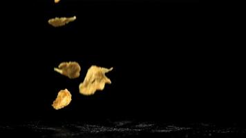 Corn flakes falling on black background. Filmed on a high-speed camera at 1000 fps. High quality FullHD footage video