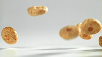 Corn flakes falling on white background. Filmed on a high-speed camera at 1000 fps. High quality FullHD footage video