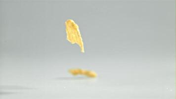 Corn flakes falling on white background. Filmed on a high-speed camera at 1000 fps. High quality FullHD footage video