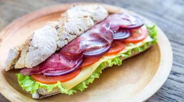 Sandwich with ham, cheese and fresh vegetables photo