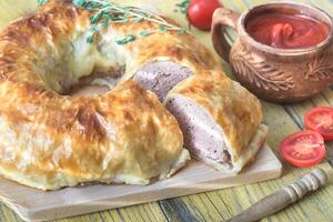 Meatball Wellington ring with tomato sauce photo