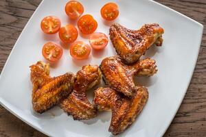 Baked chicken wings with spicy sauce photo