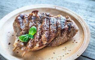 Grilled turkey on the wooden board photo