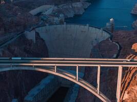 Hoover Dam on the Colorado River straddling Nevada and Arizona at dawn from above. photo