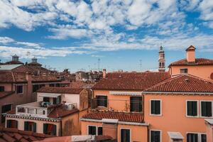 Breathtaking View of Venice Serene Rooftop Scenery Capturing Iconic Red Tiled Roofs and Canals photo