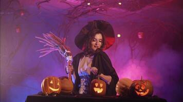 beautiful witch dancing with a broom for halloween video