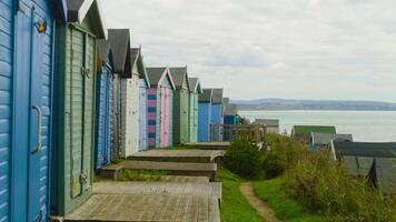 Colorful beach huts on the cliffs in England, two grades video