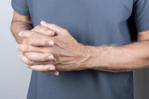 Man holding his hands folded in front of him photo