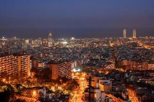 crepúsculo panorama de de barcelona iluminado horizonte y puntos de referencia foto