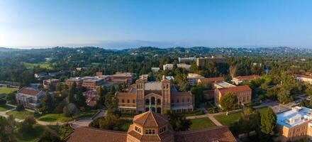 Aerial View of UCLA Campus in Westwood, Los Angeles with Red-Brick Buildings and Lush Greenery on Sunny Day photo