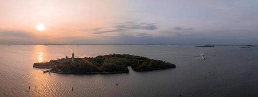 Aerial view of the plagued ghost island of Poveglia in the Venetian lagoon photo