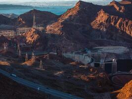 Hoover Dam on the Colorado River straddling Nevada and Arizona at dawn from above. photo