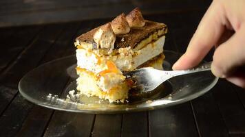 cutting a piece of truffle cake with a fork on a dark background video