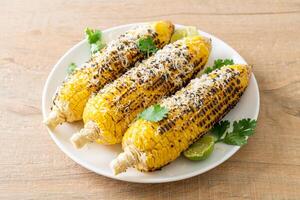 barbecue and grilled corn with cheese and lime photo