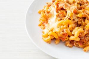 homemade macaroni bolognese with cheese photo