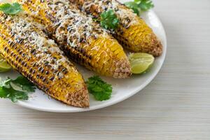 barbecue and grilled corn with cheese and lime photo