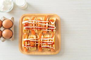 flat pancake roll with sausage and crab stick photo