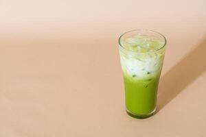 iced matcha green tea latte in glass photo