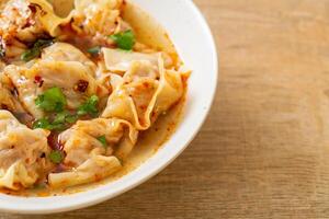 pork wonton soup or pork dumplings soup with roasted chili photo