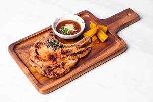 grilled pork chop steak with spicy jaew sauce photo