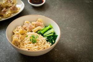 dried egg noodles with pork wonton or pork dumplings without soup photo