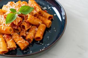 Rigatoni pasta with tomato sauce and cheese photo