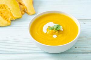 pumpkin soup in white bowl photo