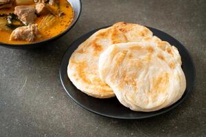 Chicken curry soup with roti photo