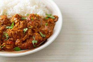 chicken tikka masala with rice on plate photo