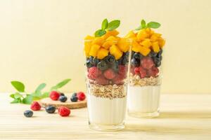 homemade mango, raspberry and blueberry with yogurt and granola photo