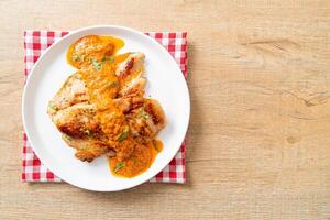 grilled chicken steak with red curry sauce photo