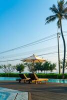 umbrella with bed pool around swimming pool with ocean sea background photo