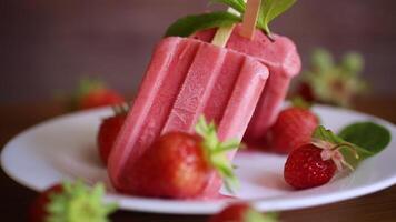 homemade strawberry ice cream on a stick made from fresh strawberries in a plate video