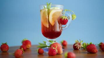 refreshing cool strawberry lemonade with lemon, ice and mint in a glass video