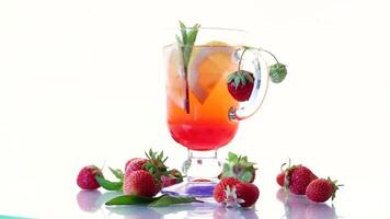 refreshing cool strawberry lemonade with lemon, ice and mint in a glass video