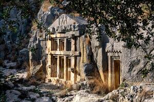 ancient tombs and crypts carved into the rocks in the ruins of Myra photo