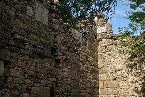 background - ancient ruins, old stone wall of a ruined building photo