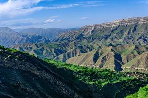 mountain landscape with a huge geological fault, a vast valley in Dagestan, the villages of Chokh and Gunib and abandoned farm Kurib are visible photo