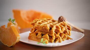 sweet baked pumpkin waffles with honey in a plate video