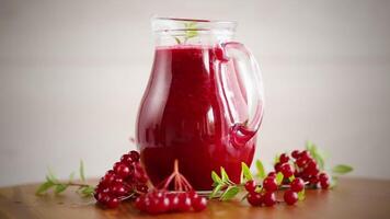 freshly squeezed thick natural juice with pulp from ripe red viburnum in a decanter video