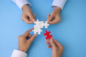 Hand of woman connecting jigsaw puzzle, Business solutions, success and strategy, Business partnership concept. photo