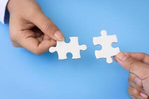 Hand of woman connecting jigsaw puzzle, Business solutions, success and strategy, Business partnership concept. photo