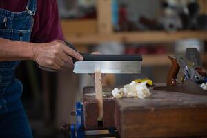 Carpenter working with equipment on wooden table. Carpenter working on woodworking machines in carpentry shop. man works in a carpentry shop. photo