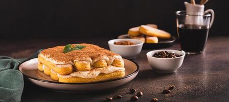 Tiramisu classic dessert with cookies, mascarpone and coffee on a plate web banner photo